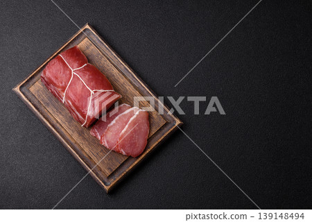 Smoked or dry cured meat slices, pork or ham with salt and spices. Smoked meat slices Smoked or dry cured meat slices, pork or ham with salt and spices. Smoked meat slices 139148494