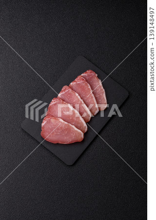 Smoked or dry cured meat slices, pork or ham with salt and spices. Smoked meat slices Smoked or dry cured meat slices, pork or ham with salt and spices. Smoked meat slices 139148497