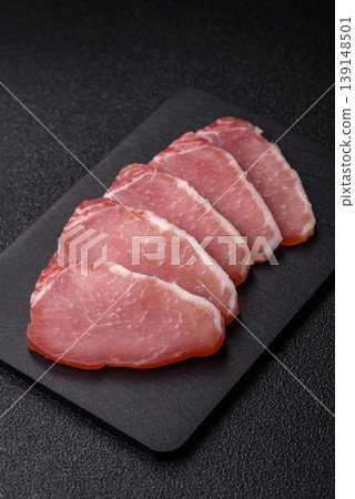 Smoked or dry cured meat slices, pork or ham with salt and spices. Smoked meat slices 139148501