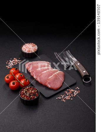 Smoked or dry cured meat slices, pork or ham with salt and spices. Smoked meat slices Smoked or dry cured meat slices, pork or ham with salt and spices. Smoked meat slices 139148507