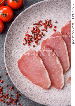 Smoked or dry cured meat slices, pork or ham with salt and spices. Smoked meat slices Smoked or dry cured meat slices, pork or ham with salt and spices. Smoked meat slices 139148512