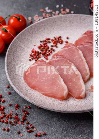 Smoked or dry cured meat slices, pork or ham with salt and spices. Smoked meat slices Smoked or dry cured meat slices, pork or ham with salt and spices. Smoked meat slices 139148513
