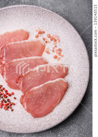 Smoked or dry cured meat slices, pork or ham with salt and spices. Smoked meat slices 139148515