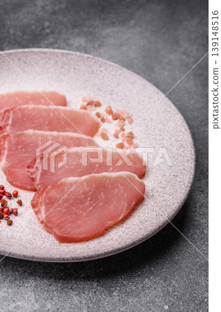 Smoked or dry cured meat slices, pork or ham with salt and spices. Smoked meat slices 139148516