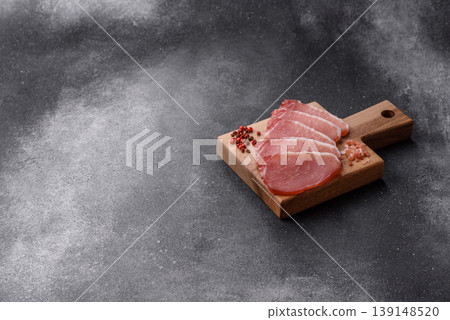 Smoked or dry cured meat slices, pork or ham with salt and spices. Smoked meat slices Smoked or dry cured meat slices, pork or ham with salt and spices. Smoked meat slices 139148520