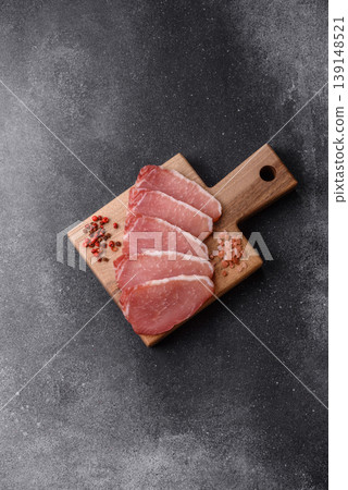 Smoked or dry cured meat slices, pork or ham with salt and spices. Smoked meat slices Smoked or dry cured meat slices, pork or ham with salt and spices. Smoked meat slices 139148521