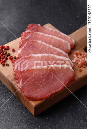 Smoked or dry cured meat slices, pork or ham with salt and spices. Smoked meat slices 139148525