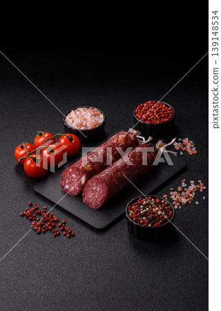 Smoked or dry cured salami slices or ham with salt and spices. Smoked sausage Smoked or dry cured salami slices or ham with salt and spices. Smoked sausage 139148534