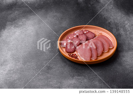 Smoked or dry cured salami slices or ham with salt and spices. Smoked sausage Smoked or dry cured salami slices or ham with salt and spices. Smoked sausage 139148555