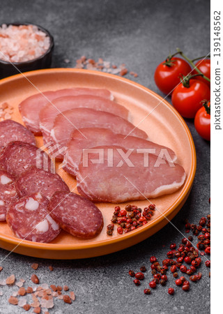 Smoked or dry cured salami slices or ham with salt and spices. Smoked sausage Smoked or dry cured salami slices or ham with salt and spices. Smoked sausage 139148562
