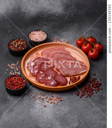 Smoked or dry cured salami slices or ham with salt and spices. Smoked sausage Smoked or dry cured salami slices or ham with salt and spices. Smoked sausage 139148565