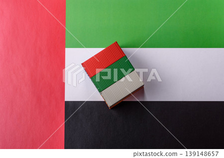 Cargo containers on the UAE flag as a conceptual backdrop for goods export. Cargo containers 139148657