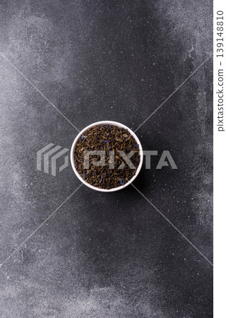 Granules of dried organic Chinese green tea with herbal additives. Dry green tea Granules of dried organic Chinese green tea with herbal additives. Dry green tea 139148810