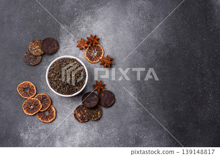 Granules of dried organic Chinese green tea with herbal additives. Dry green tea 139148817
