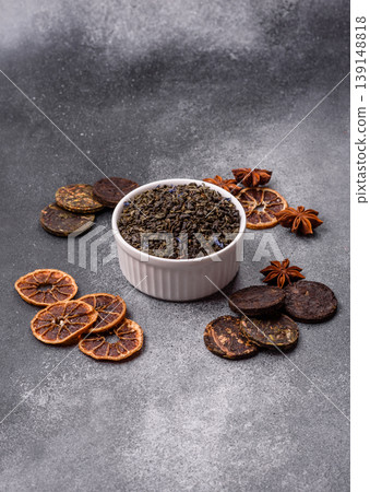 Granules of dried organic Chinese green tea with herbal additives. Dry green tea Granules of dried organic Chinese green tea with herbal additives. Dry green tea 139148818