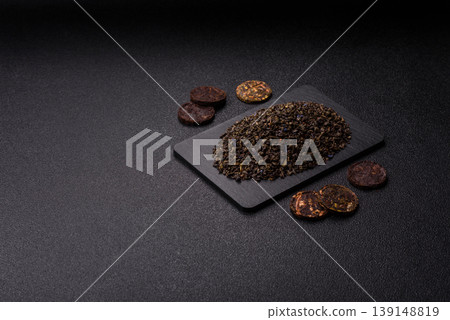 Granules of dried organic Chinese green tea with herbal additives. Dry green tea Granules of dried organic Chinese green tea with herbal additives. Dry green tea 139148819