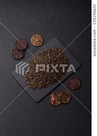 Granules of dried organic Chinese green tea with herbal additives. Dry green tea Granules of dried organic Chinese green tea with herbal additives. Dry green tea 139148820