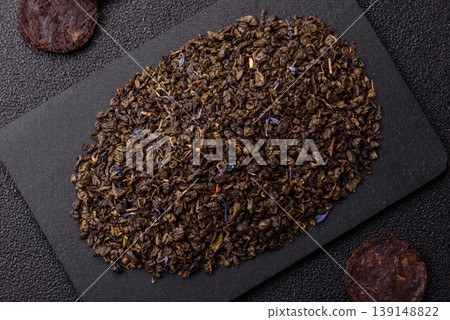 Granules of dried organic Chinese green tea with herbal additives. Dry green tea 139148822