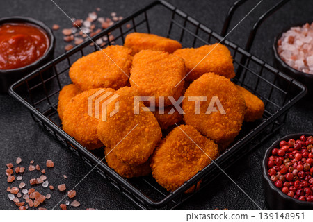 Fried chicken nuggets with sauce, salt, and spices, fast food, unhealthy food. Chicken nuggets Fried chicken nuggets with sauce, salt, and spices, fast food, unhealthy food. Chicken nuggets 139148951