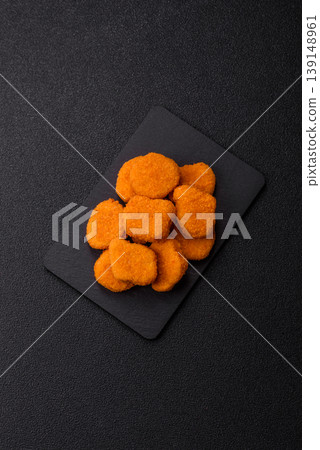 Fried chicken nuggets with sauce, salt, and spices, fast food, unhealthy food. Chicken nuggets Fried chicken nuggets with sauce, salt, and spices, fast food, unhealthy food. Chicken nuggets 139148961