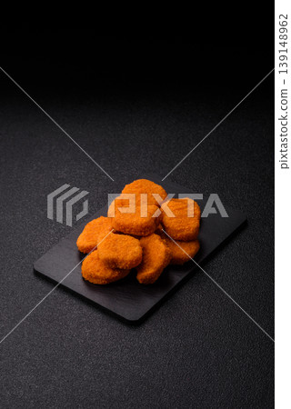 Fried chicken nuggets with sauce, salt, and spices, fast food, unhealthy food. Chicken nuggets 139148962