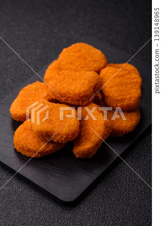 Fried chicken nuggets with sauce, salt, and spices, fast food, unhealthy food. Chicken nuggets Fried chicken nuggets with sauce, salt, and spices, fast food, unhealthy food. Chicken nuggets 139148965