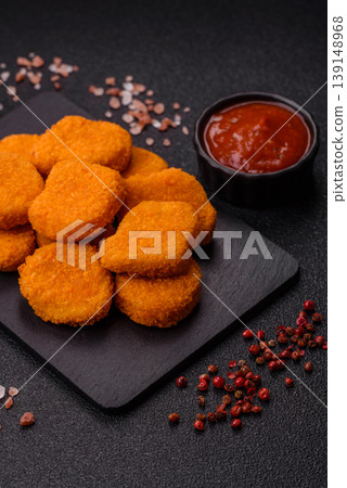 Fried chicken nuggets with sauce, salt, and spices, fast food, unhealthy food. Chicken nuggets Fried chicken nuggets with sauce, salt, and spices, fast food, unhealthy food. Chicken nuggets 139148968