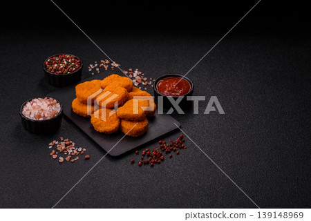 Fried chicken nuggets with sauce, salt, and spices, fast food, unhealthy food. Chicken nuggets Fried chicken nuggets with sauce, salt, and spices, fast food, unhealthy food. Chicken nuggets 139148969