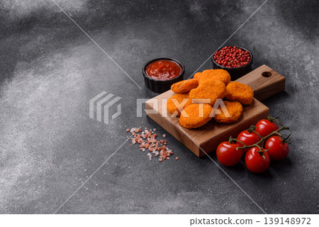 Fried chicken nuggets with sauce, salt, and spices, fast food, unhealthy food. Chicken nuggets Fried chicken nuggets with sauce, salt, and spices, fast food, unhealthy food. Chicken nuggets 139148972