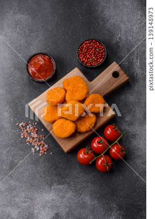 Fried chicken nuggets with sauce, salt, and spices, fast food, unhealthy food. Chicken nuggets Fried chicken nuggets with sauce, salt, and spices, fast food, unhealthy food. Chicken nuggets 139148973