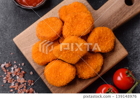 Fried chicken nuggets with sauce, salt, and spices, fast food, unhealthy food. Chicken nuggets Fried chicken nuggets with sauce, salt, and spices, fast food, unhealthy food. Chicken nuggets 139148976