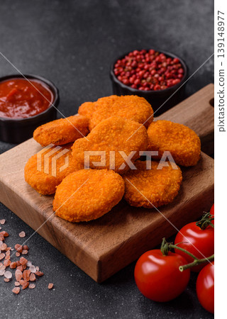 Fried chicken nuggets with sauce, salt, and spices, fast food, unhealthy food. Chicken nuggets Fried chicken nuggets with sauce, salt, and spices, fast food, unhealthy food. Chicken nuggets 139148977