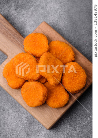 Fried chicken nuggets with sauce, salt, and spices, fast food, unhealthy food. Chicken nuggets Fried chicken nuggets with sauce, salt, and spices, fast food, unhealthy food. Chicken nuggets 139148979
