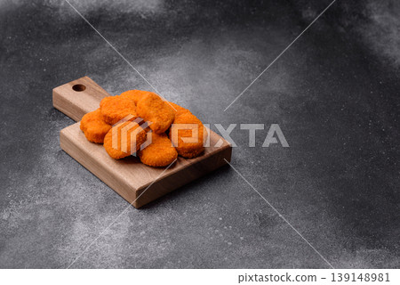 Fried chicken nuggets with sauce, salt, and spices, fast food, unhealthy food. Chicken nuggets Fried chicken nuggets with sauce, salt, and spices, fast food, unhealthy food. Chicken nuggets 139148981