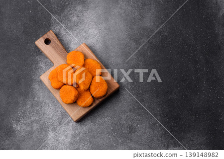 Fried chicken nuggets with sauce, salt, and spices, fast food, unhealthy food. Chicken nuggets Fried chicken nuggets with sauce, salt, and spices, fast food, unhealthy food. Chicken nuggets 139148982