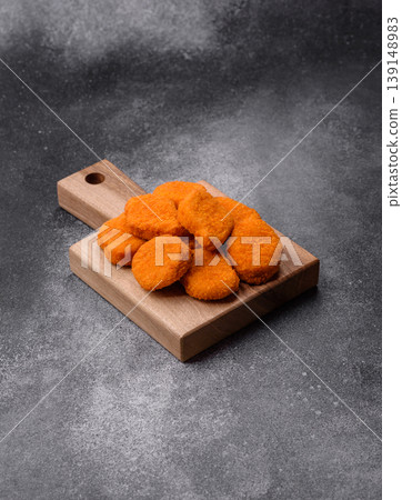 Fried chicken nuggets with sauce, salt, and spices, fast food, unhealthy food. Chicken nuggets Fried chicken nuggets with sauce, salt, and spices, fast food, unhealthy food. Chicken nuggets 139148983