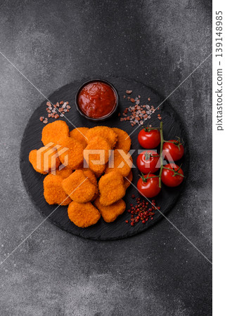 Fried chicken nuggets with sauce, salt, and spices, fast food, unhealthy food. Chicken nuggets 139148985