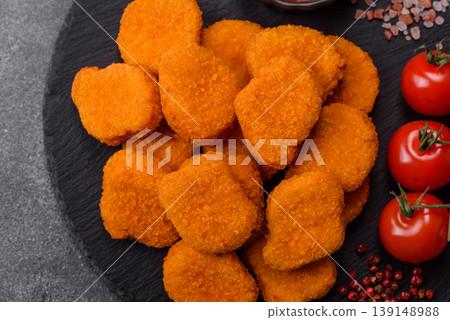 Fried chicken nuggets with sauce, salt, and spices, fast food, unhealthy food. Chicken nuggets 139148988