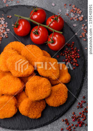 Fried chicken nuggets with sauce, salt, and spices, fast food, unhealthy food. Chicken nuggets Fried chicken nuggets with sauce, salt, and spices, fast food, unhealthy food. Chicken nuggets 139148991