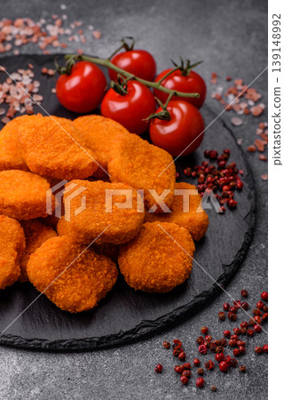 Fried chicken nuggets with sauce, salt, and spices, fast food, unhealthy food. Chicken nuggets 139148992