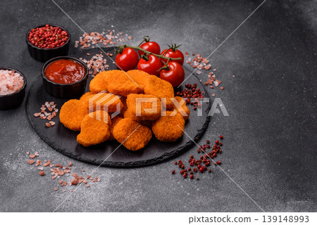 Fried chicken nuggets with sauce, salt, and spices, fast food, unhealthy food. Chicken nuggets 139148993