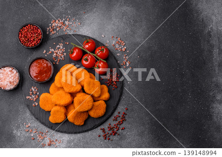 Fried chicken nuggets with sauce, salt, and spices, fast food, unhealthy food. Chicken nuggets Fried chicken nuggets with sauce, salt, and spices, fast food, unhealthy food. Chicken nuggets 139148994