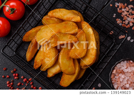 Potato wedges baked with garlic, herbs, and spices for lunch. Potato wedges Potato wedges baked with garlic, herbs, and spices for lunch. Potato wedges 139149023