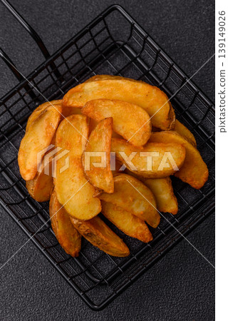 Potato wedges baked with garlic, herbs, and spices for lunch. Potato wedges Potato wedges baked with garlic, herbs, and spices for lunch. Potato wedges 139149026