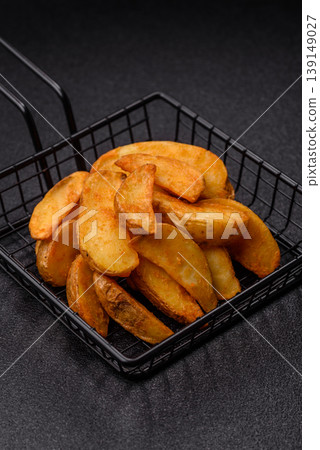 Potato wedges baked with garlic, herbs, and spices for lunch. Potato wedges 139149027