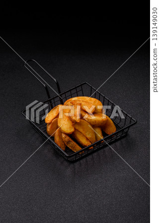 Potato wedges baked with garlic, herbs, and spices for lunch. Potato wedges 139149030