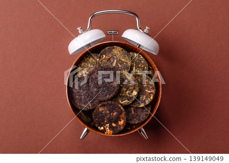 Organic Chinese green pu-erh tea with various herbs in round bricks. Chinese pu-erh tea 139149049