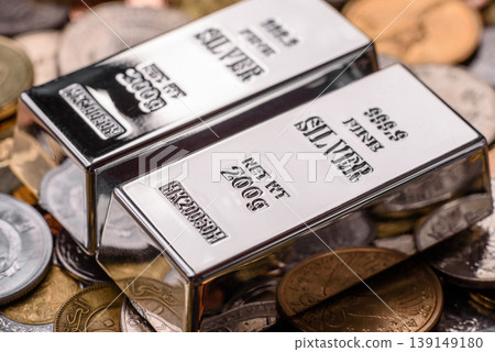 A silver bar, white metal against a backdrop of money, as a concept for the sales. A silver bar A silver bar, white metal against a backdrop of money, as a concept for the sales. A silver bar 139149180