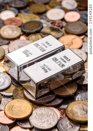 A silver bar, white metal against a backdrop of money, as a concept for the sales. A silver bar A silver bar, white metal against a backdrop of money, as a concept for the sales. A silver bar 139149183