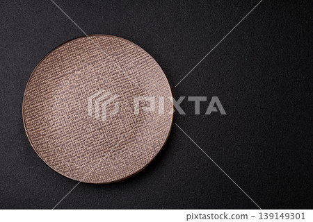 An empty ceramic round plate, kitchen utensils for a dinner table. An empty plate 139149301
